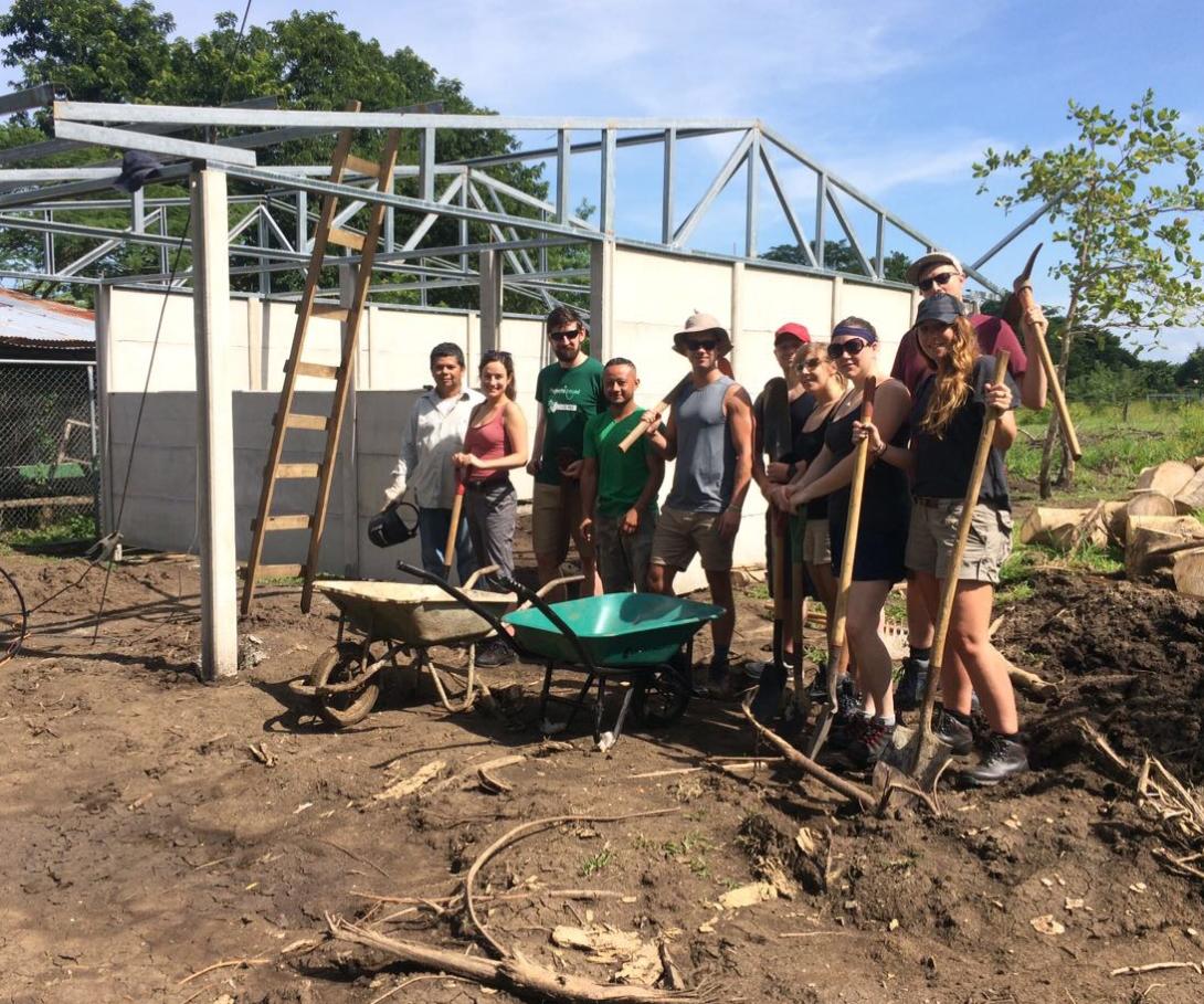 A group of corporate volunteers on a tailor-made trip take a break during building activities in Costa Rica. A corporate group on a bespoke volunteer trip at their building site in Costa Rica.